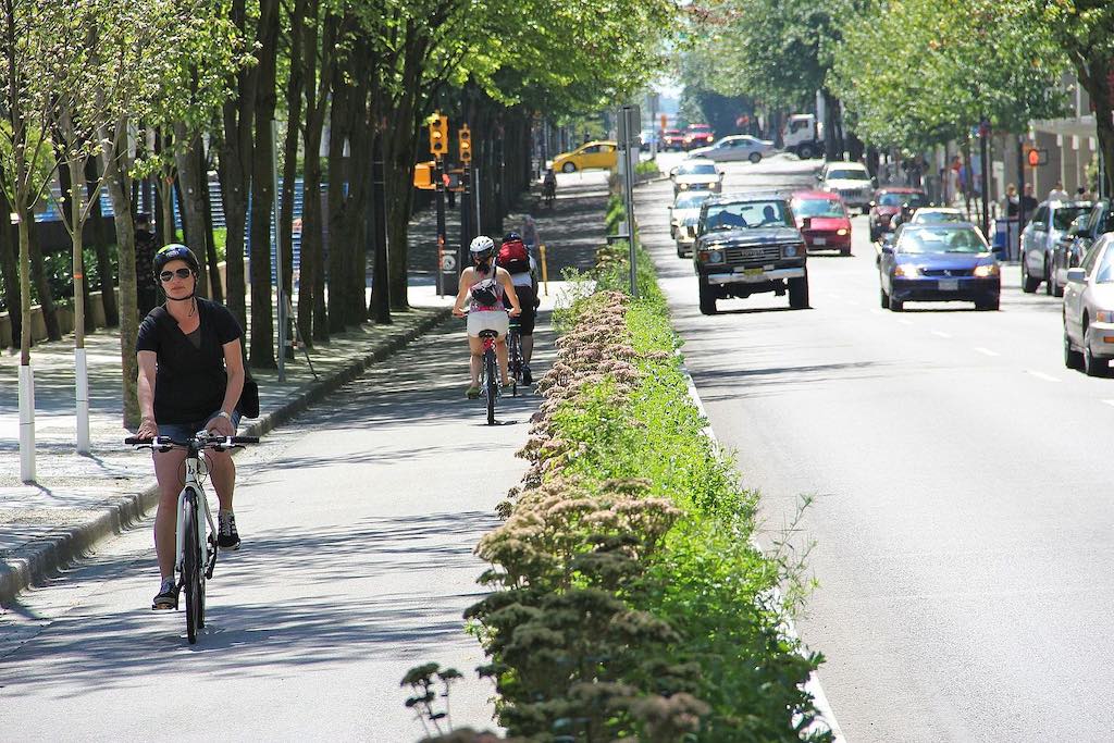 Active transportation as people cycle on Hornby Street bike lane in Vancouver