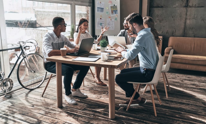 A New York software development company team meeting for pre- and post-launch quality assurance