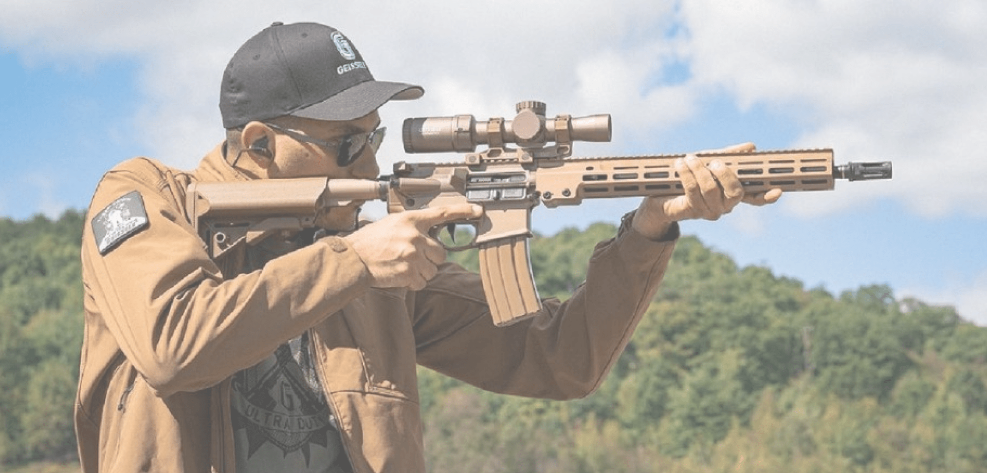 A man looks down the visor of his gun